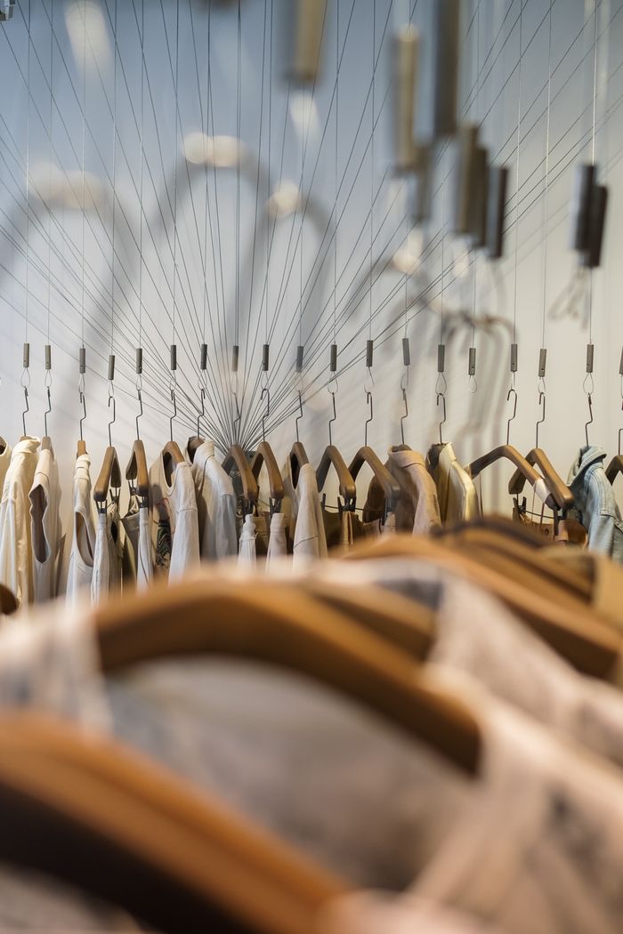 About A stylish arrangement of clothes on hangers in a chic fashion boutique.