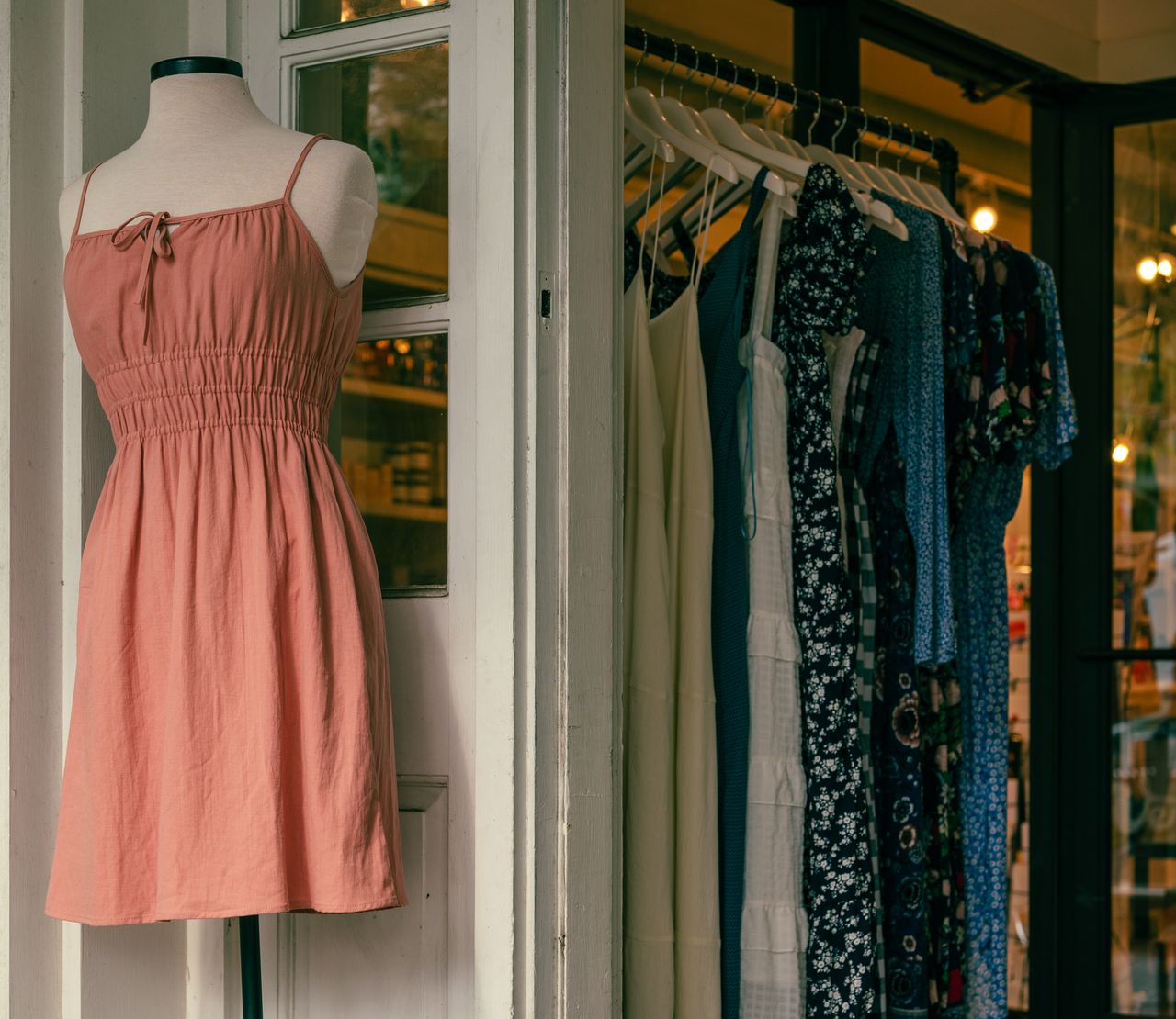 Mastering the First Impression: Your intriguing post title goes here Mannequin with a pink dress and clothing rack in a stylish boutique.
